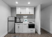Thumbnail 11 of 11 - a kitchen with white cabinets and a refrigerator
